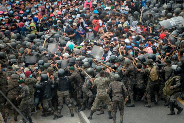 Honduran migrants, part of a caravan heading to the United States, clash with Guatemalan security forces in Vado Hondo, Guatemala, on Jan. 17, 2021. (Johan Ordonez/AFP via Getty Images)