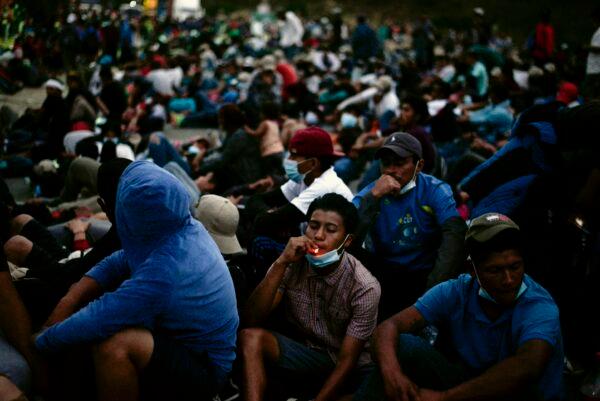 Honduran migrants, part of a caravan heading to the United States, take a rest in Vado Hondo, Guatemala, on Jan. 17, 2021. (Johan Ordonez/AFP via Getty Images)