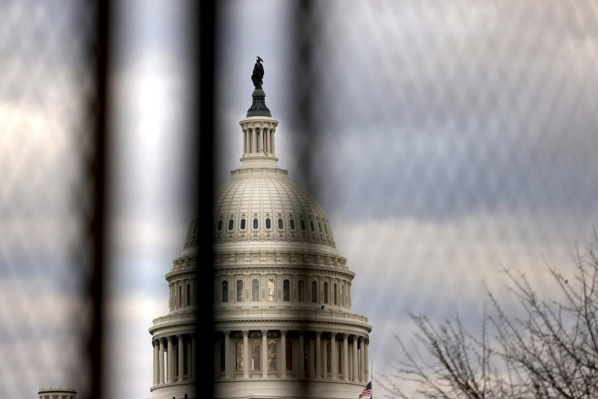 The U.S. Capitol dome is seen beyond a security fence in Washington, on Jan. 17, 2021. (Michael M. Santiago/Getty Images)