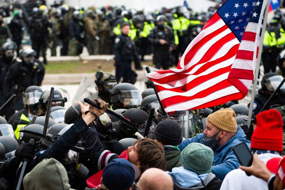 Protesters fight with riot police outside the Capitol building in Washington on Jan. 6, 2021. (Roberto Schmidt/AFP via Getty Images)