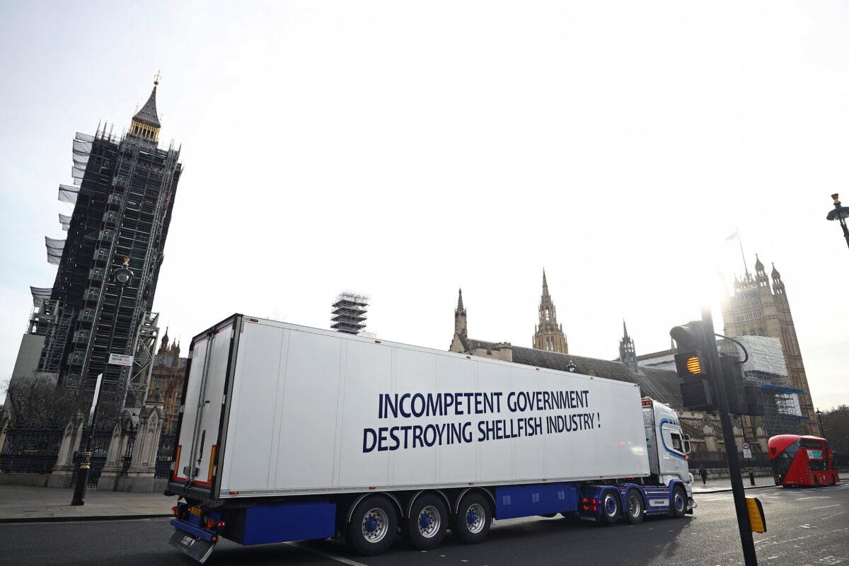 A lorry with a sign in protest against post-Brexit bureaucracy that hinders exports to the European Union, drives at Parliament Square in London, on Jan. 18, 2021. (Hannah McKay/Reuters)