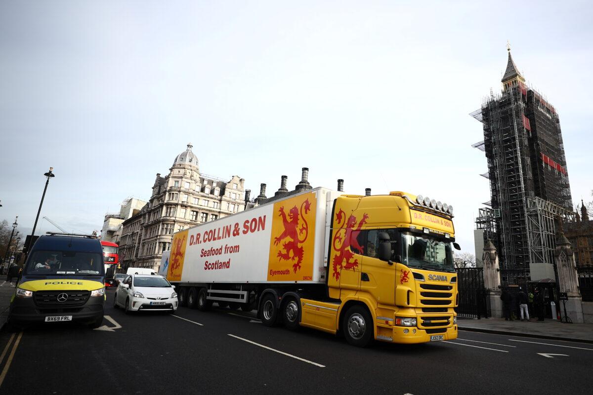 A lorry drives during a protest against post-Brexit bureaucracy that hinders exports to the European Union, at the Parliament Square in London, on Jan. 18, 2021. (Hannah McKay/Reuters)