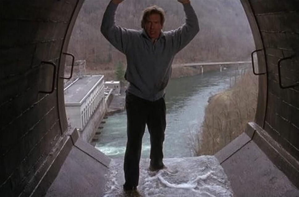 Dr. Richard Kimble (Harrison Ford) about to jump off a high dam to escape a U.S. marshal, in “The Fugitive.” (Warner Bros.)