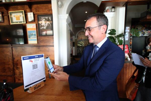 South Australian Premier Steven Marshall demonstrates checking in via QR code to help with contact tracing at the Stag Hotel in Adelaide, Australia on December 01, 2020. (Kelly Barnes/Getty Images)