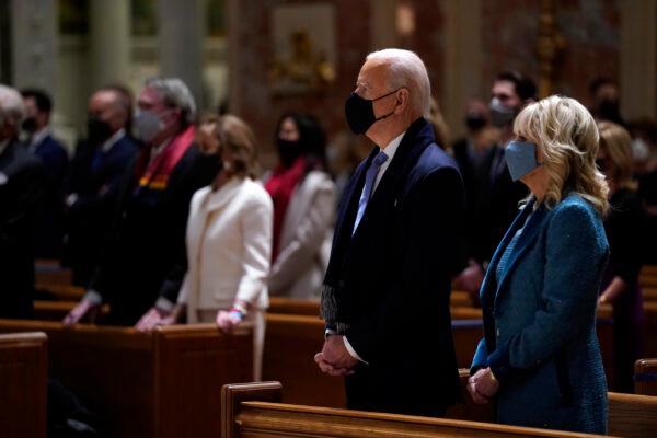 President Joe Biden is joined his wife Jill Biden as they celebrate Mass at the Cathedral of St. Matthew the Apostle on Inauguration Day in Washington on Jan. 20, 2021. (Evan Vucci/AP Photo)