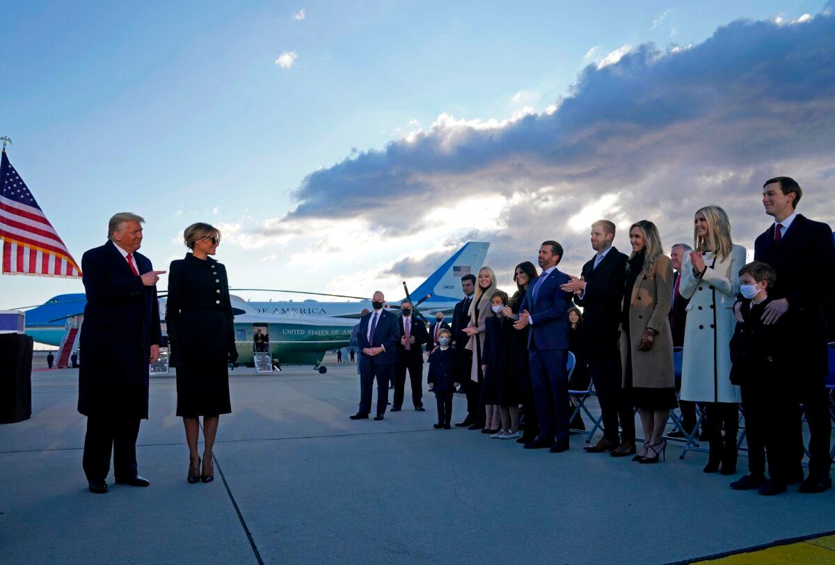 President Donald Trump and First Lady Melania Trump are greeted by Ivanka Trump (2nd R), husband Jared Kushner (R), their children, Eric (C-R) and Donald Jr. (C-L), Tiffany Trump, and other Trump family members on the tarmac at Joint Base Andrews in Maryland on Jan. 20, 2021. (Alex Edelman/AFP via Getty Images)