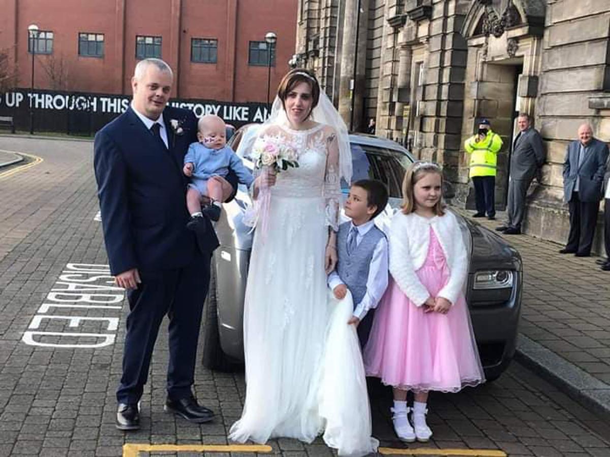 James and Sarah with baby Louis, son Bobbie, and daughter Lily-Grace on their wedding day. (Caters News)