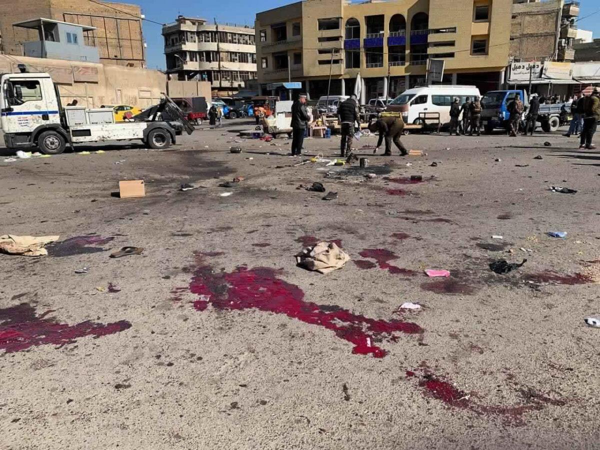 Security forces work at the site of a deadly bomb attack in a market selling used clothes, Iraq, on Jan. 21, 2021. (Hadi Mizban/AP Photo)