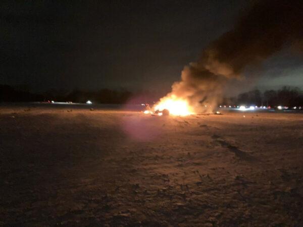 Image shows the aircraft wreckage burning in Mendon, some 13 miles south of Rochester, New York. (Courtesy of Emily Fasel)