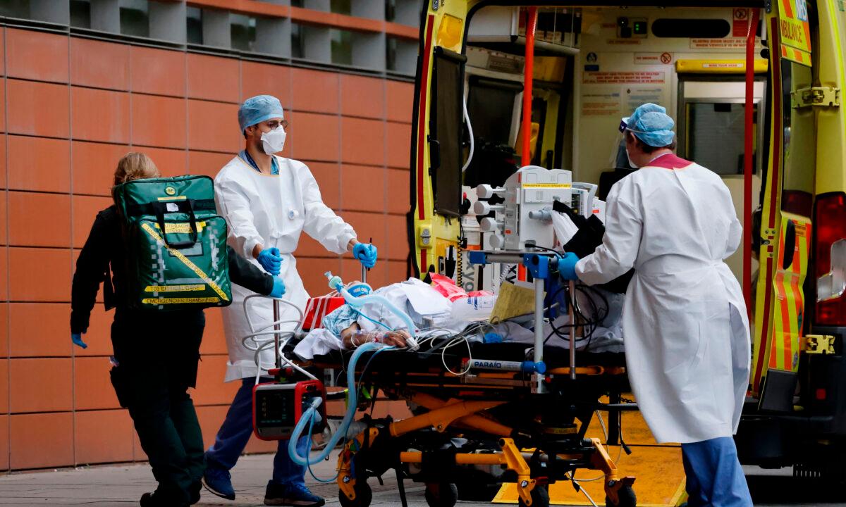 Medics take a patient from an ambulance into the Royal London hospital in London on Jan. 19, 2021. (Tolga Akmen/AFP via Getty Images)