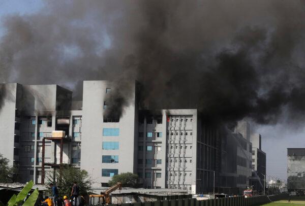  Firemen try to douse a fire at Serum Institute of India, the world's largest vaccine maker that is manufacturing the AstraZeneca/Oxford University vaccine for the CCP virus, in Pune, India, on Jan. 21, 2021. (Rafiq Maqbool/AP Photo)
