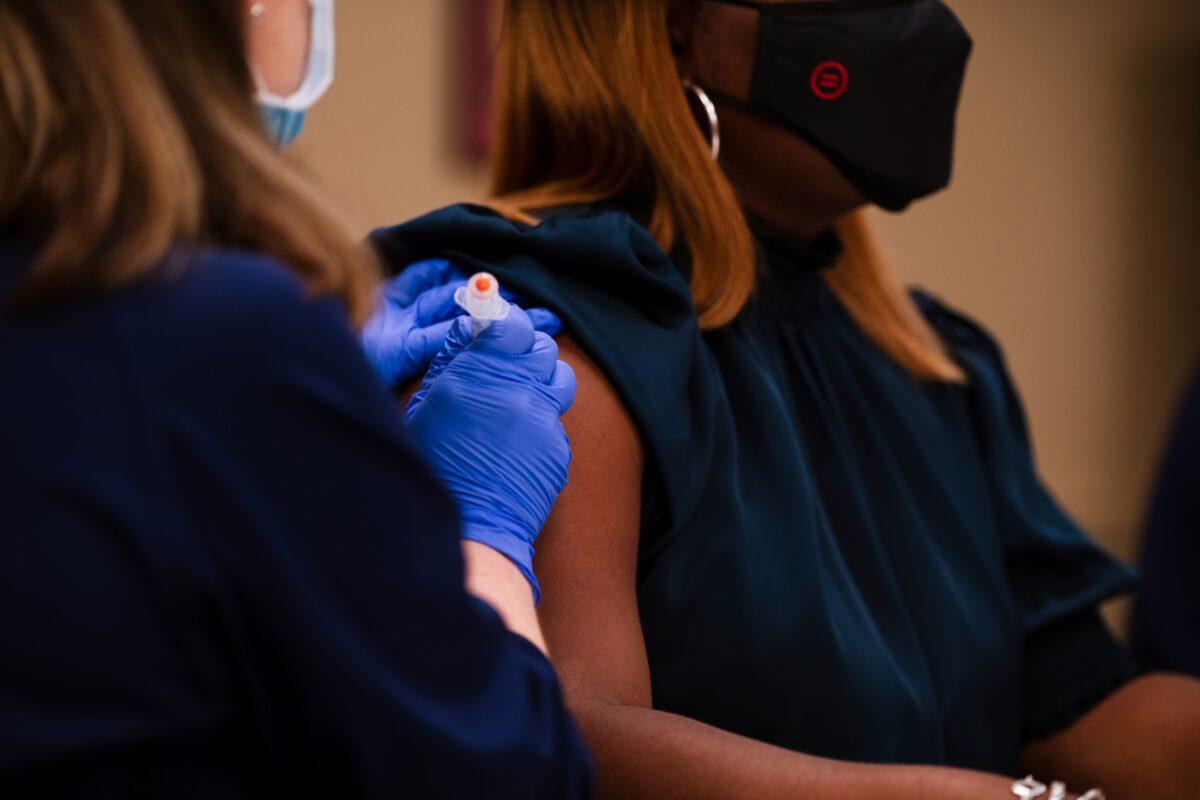 Sadiqa Reynolds, president and CEO of the Louisville Urban League, receives the Moderna COVID-19 vaccine at the Louisville Urban League in Louisville, Ky., on Jan. 20, 2021. (Jon Cherry/Getty Images)