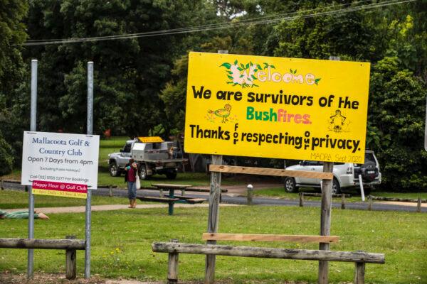 A sign reading "We are survivors of the bushfires" is shown at Maurice Avenue round about in Mallacoota, Australia on Dec. 31, 2020. (Diego Fedele/Getty Images)