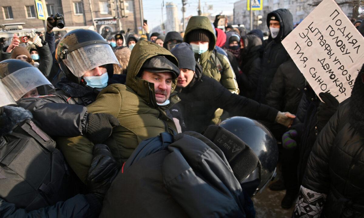 A protester is taken away by law enforcement officers during a rally in support of jailed Russian opposition leader Alexei Navalny in Omsk, Russia, on Jan. 23, 2021. (Alexey Malgavko/Reuters)