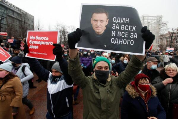 A participant holds a placard reading "One for all, all for one" during a rally in support of jailed Russian opposition leader Alexei Navalny in Moscow on Jan. 23, 2021. (Maxim Shemetov/ Reuters)