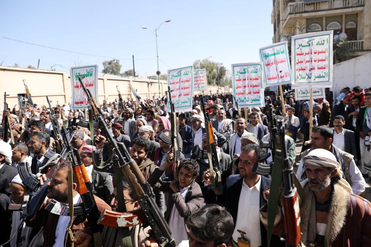 Houthi supporters hold up their weapons during a demonstration against the United States decision to designate the Houthis as a foreign terrorist organization, in Sanaa, Yemen, on Jan. 20, 2021. (Khaled Abdullah/Reuters)