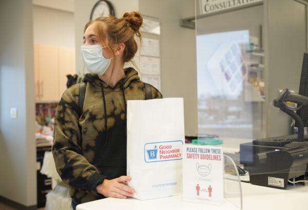 McKenna Thompson gets ready for the last delivery of the day at Brehme Drug in Manchester, Iowa, on Jan. 16, 2021. (Cara Ding/The Epoch Times)