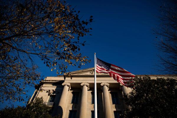 An American flag waves outside the U.S. Department of Justice Building in Washington on Dec. 15, 2020. (Al Drago/Reuters)