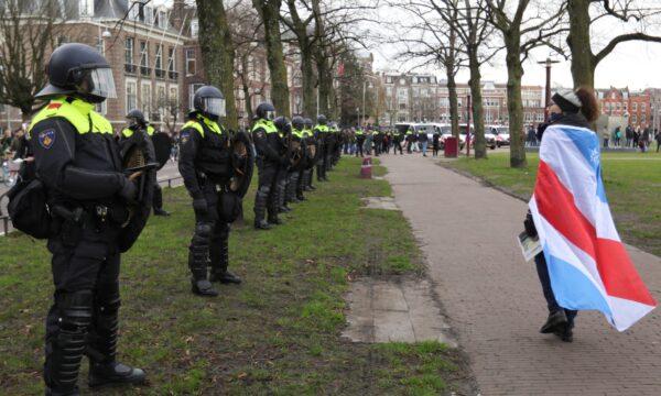 Police officers line up during a protest against COVID-19 restrictions, in Amsterdam, Netherlands, on Jan. 24, 2021. (Eva Plevier/Reuters)