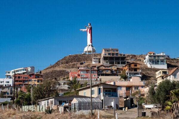 A statue of Jesus looks over a small coastal town in Baja California, Mexico, on Jan. 16, 2021. (John Fredricks/The Epoch Times)