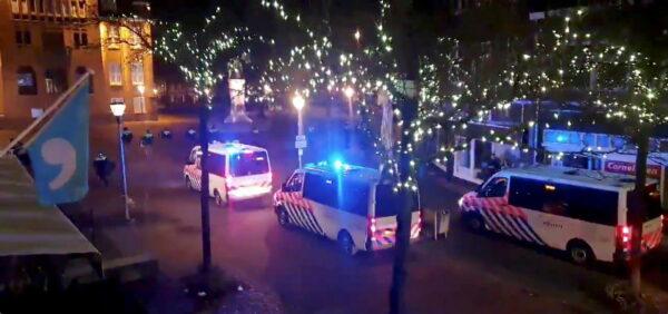 Police officers and vehicles arrive to disperse people from out from the site of one of the coronavirus disease (COVID-19) curfew protests in Geleen, Netherlands, on Jan. 25, 2021, in this still image from video obtained from social media. (Evert Bopp via Reuters)