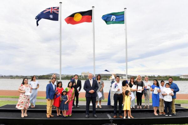 Prime Minister Scott Morrison poses for a photo with new citizens during an Australia Day Citizenship Ceremony and Flag Raising event in Canberra, on Tuesday, Jan. 26, 2021. (AAP Image/Mick Tsikas)