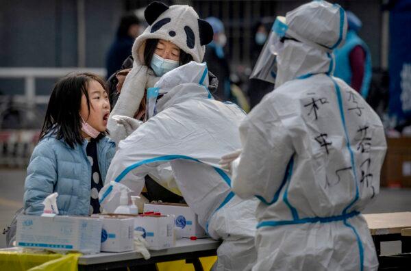 A girl is swabbed by health workers as she is given a COVID-19 nucleic acid test in Dongcheng District in Beijing, China on Jan. 23, 2021. (Kevin Frayer/Getty Images)