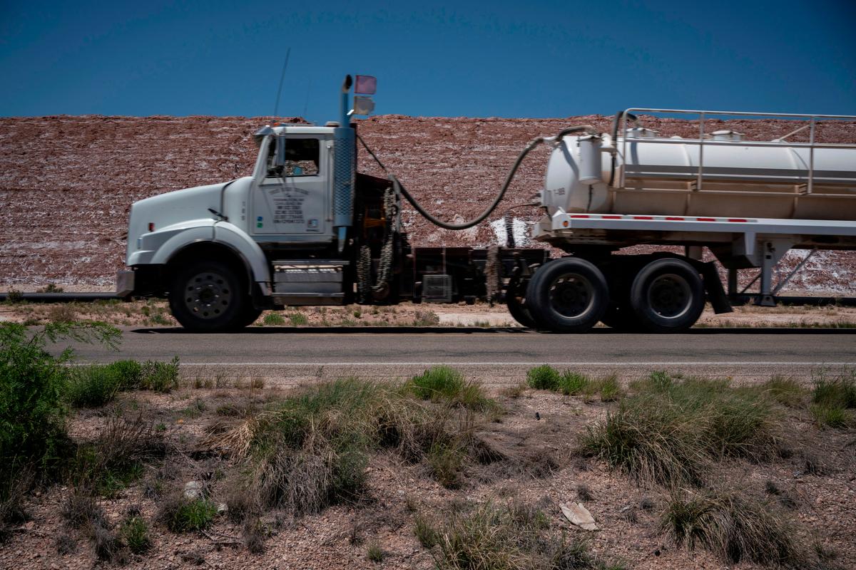 A semi-truck carrying oil passes by a quarry in Eddy County, New Mexico, on April 23, 2020. (PAUL RATJE/AFP via Getty Images)