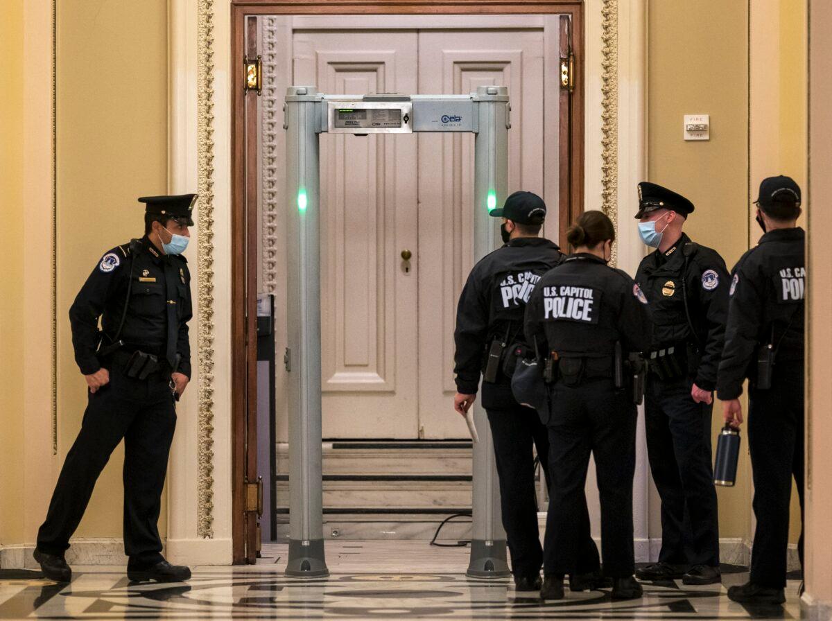 U.S. Capitol Police survey the corridor around the House of Representatives chamber after enhanced security protocols were enacted, including metal detectors for lawmakers, after protesters stormed the Capitol, in Washington on Jan. 12, 2021. (J. Scott Applewhite/AP Photo)
