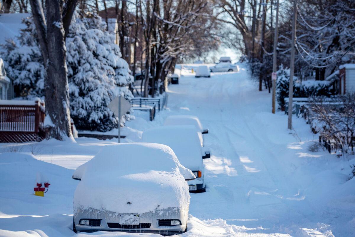 Snow covers cars and Blondo Street east of Northwest Radial Highway in Omaha, Neb., on Jan. 26, 2021. (Chris Machian/Omaha World-Herald via AP)
