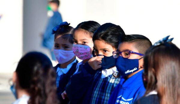 A student adjusts her facemask at St. Joseph Catholic School in La Puente, Calif., on Nov. 16, 2020. (Frederic J. Brown/AFP via Getty Images)