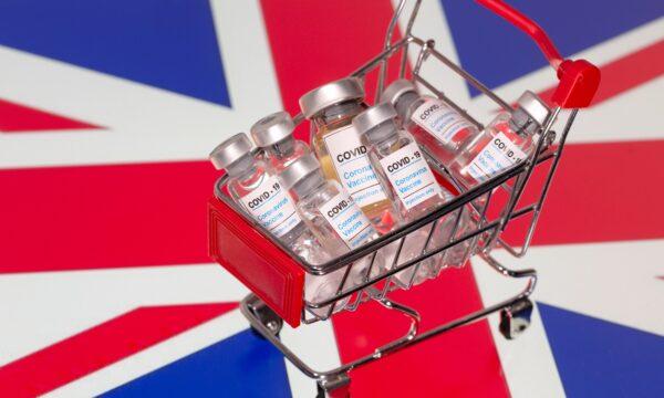 A small shopping basket filled with vials labeled "COVID-19 - Coronavirus Vaccine" is placed on a UK flag in this illustration taken Nov. 29, 2020. (Dado Ruvic/Ilustration/Reuters)