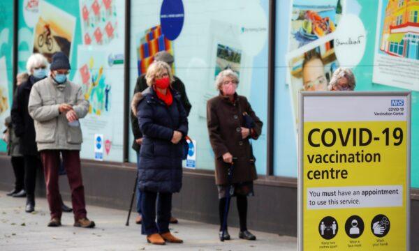 People queue to receive the CCP virus vaccine outside a closed down Debenhams store that is being used as a vaccination center in Folkestone, Kent, United Kingdom, on Jan. 28, 2021. (Andrew Couldridge/Reuters)