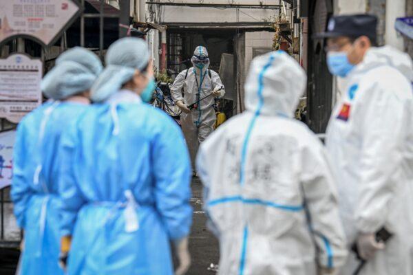 Health workers spray disinfectant in a blocked off area in Shanghai's Huangpu district, China, on Jan. 27, 2021. (STR/AFP via Getty Images)