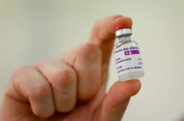 A vial of the COVID-19 vaccine developed by Oxford University and UK-based drugmaker AstraZeneca is checked as they arrive at the Princess Royal Hospital in Haywards Heath, England, on Jan. 2, 2021. (Gareth Fuller/Pool via AP)