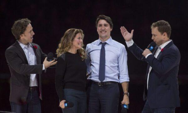 WE Charity co-founders Craig (L) and Marc (R) Kielburger introduce Prime Minister Justin Trudeau and his wife Sophie Gregoire-Trudeau as they appear at the WE Day celebrations in Ottawa on Nov. 10, 2015. (Adrian Wyld/The Canadian Press)