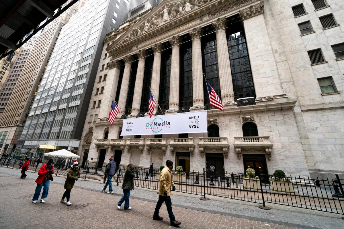 Pedestrians pass the New York Stock Exchange, in New York, on Jan. 27, 2021. (John Minchillo/AP Photo)