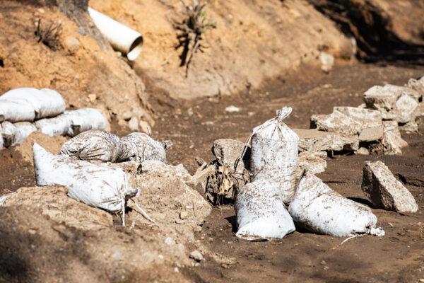 Scattered sandbags sit in the mud in Williams Canyon, Calif., on Jan. 28, 2021. (John Fredricks/The Epoch Times)