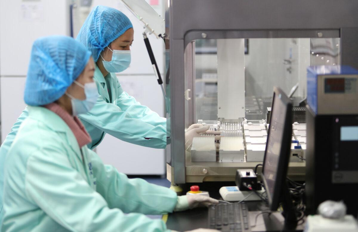 Technicians work at a genetic testing laboratory of BGI in Kunming, Yunnan Province, China, on Dec. 26, 2018. (Stringer/Reuters)