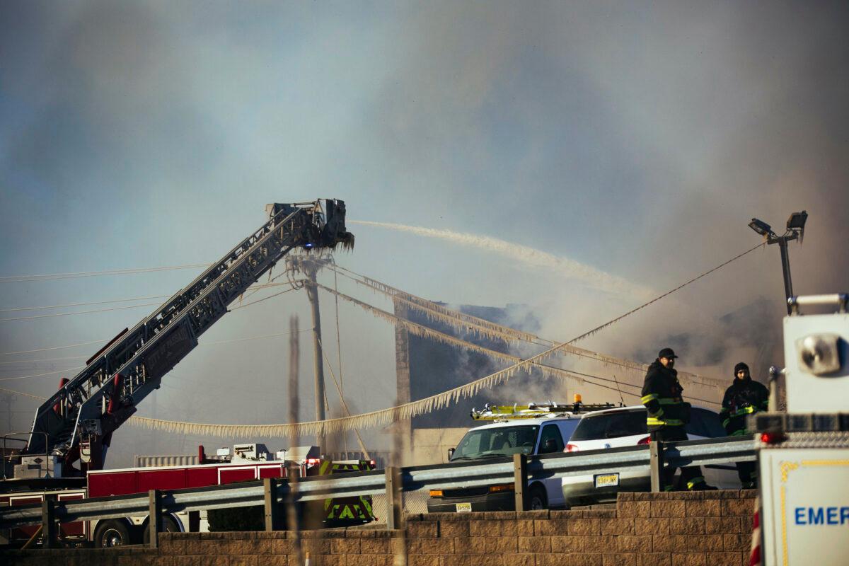 Firefighters battle a blaze in an industrial area in Passaic, N.J., on Saturday, Jan. 30, 2021. (Kevin Hagen/AP)