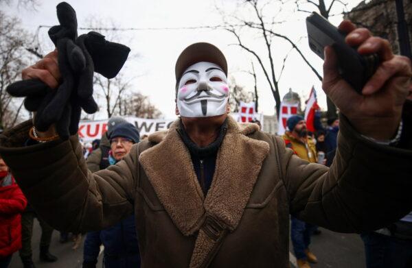 A man wearing a mask gestures during a demonstration against the coronavirus disease (COVID-19) measures and their economic consequences in Vienna, Austria, on Jan. 31, 2021. (Lisi Niesner/Reuters)