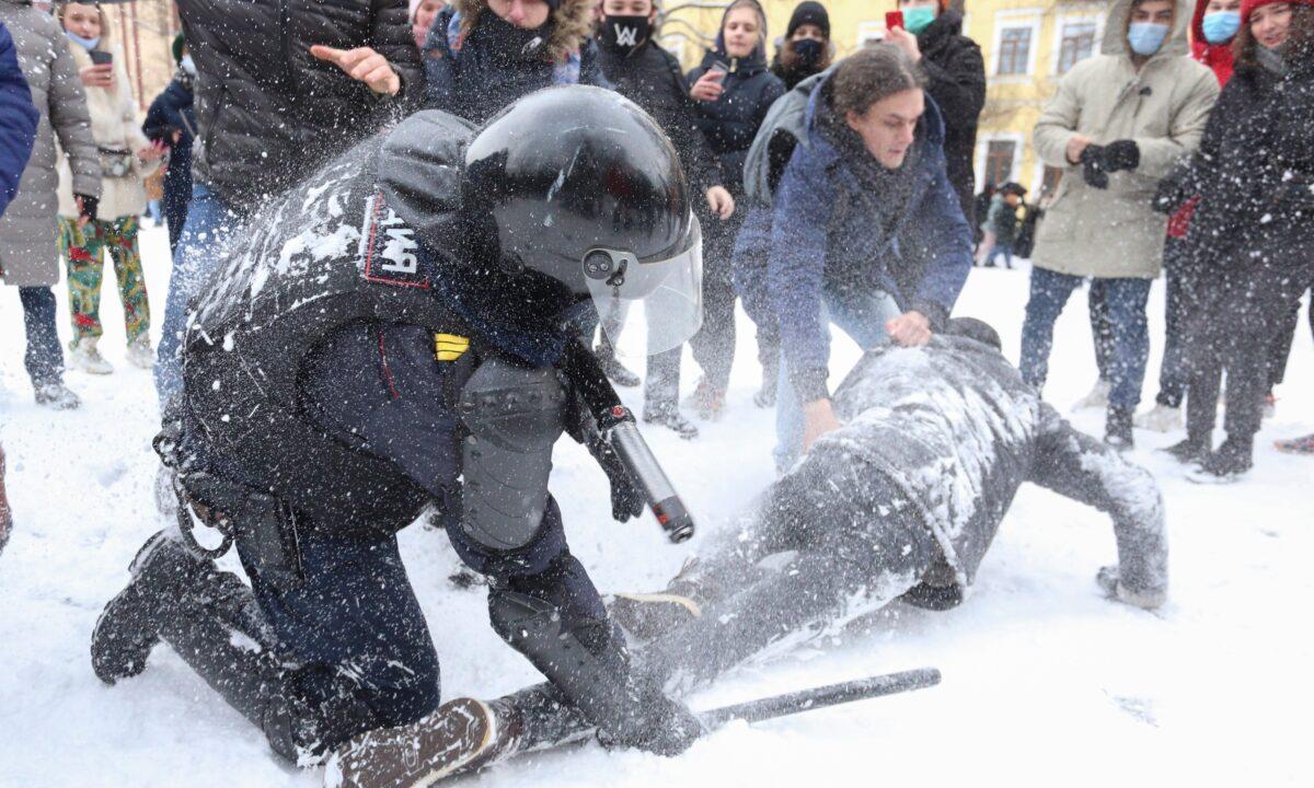 A policeman detains a man while protesters try to help him, during a protest against the jailing of opposition leader Alexei Navalny in St. Petersburg, Russia, on Jan. 31, 2021. (Valentin Egorshin/AP Photo)