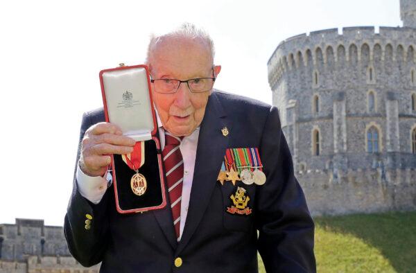 Captain Sir Thomas Moore poses for the media after receiving his knighthood from Britain's Queen Elizabeth, during a ceremony at Windsor Castle in Windsor, England, on July 17, 2020. (Chris Jackson/Pool Photo via AP, File)