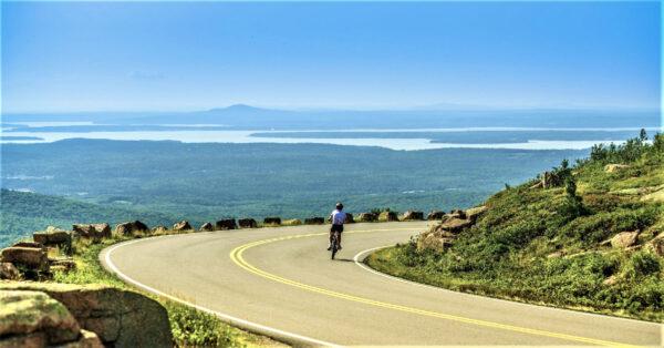 A cyclist pedals down Cadillac Mountain in Maine's Acadia National Park. (Courtesy of Jinnee/Dreamstime.com)