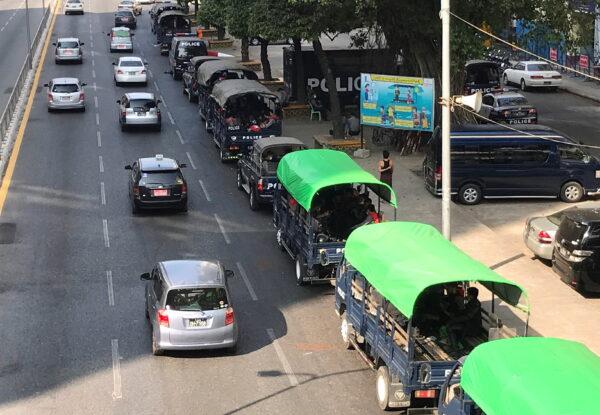 Burmese police vehicles drive near the City Hall in Yangon, Burma, on Feb. 1, 2021. (Stringer/Reuters)