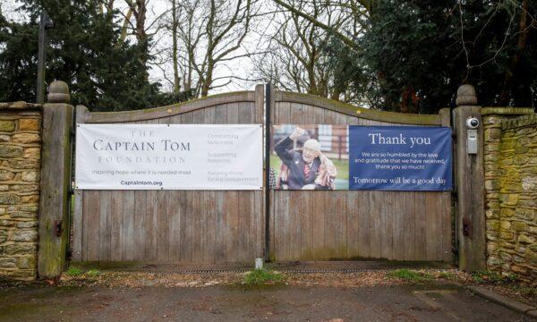 A poster supporting The Captian Tom Moore Foundation is seen as the centenarian fundraiser Captain Sir Tom Moore is taken to a hospital after testing positive for the coronavirus disease (COVID-19) during treatment for pneumonia, in Marston Moretaine near Milton Keynes, Britain, on Feb. 1, 2021. (Andrew Boyers/Reuters)