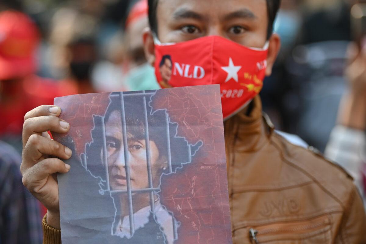 A Burmese migrant holds up an image of Aung San Suu Kyi during a demonstration outside the Burmese embassy in Bangkok on Feb. 1, 2021. (Lillian Suwanrumpha/AFP via Getty Images)