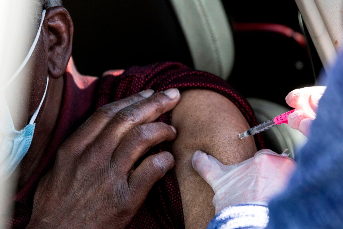 A man gets his first dose of the COVID-19 vaccine administered during mass vaccinations at Coors Field baseball stadium in Denver, Colo., on Jan. 30, 2021. (Chet Strange/AFP via Getty Images)
