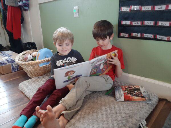 Lochlan Shannon, aged 7, reads to his younger brother Landon at home in Airdrie, Alberta, as part of his home learning amid the pandemic. (Courtesy Samantha Shannon)