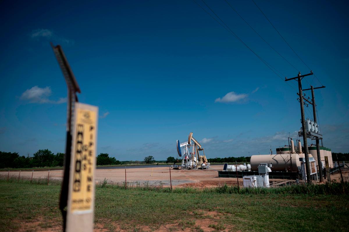 Two oil pumpjacks on May 4, 2020, in Cushing, Oklahoma. (JOHANNES EISELE/AFP via Getty Images)